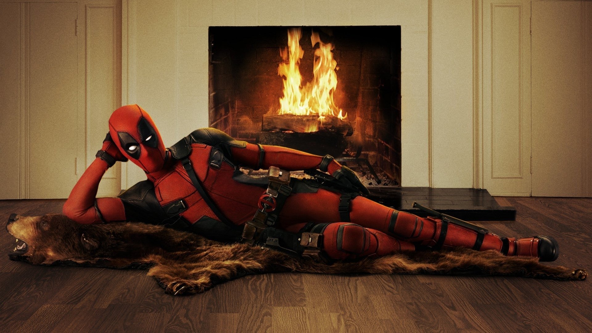 Deadpool reclining on a bearskin rug by a fireplace, promo image